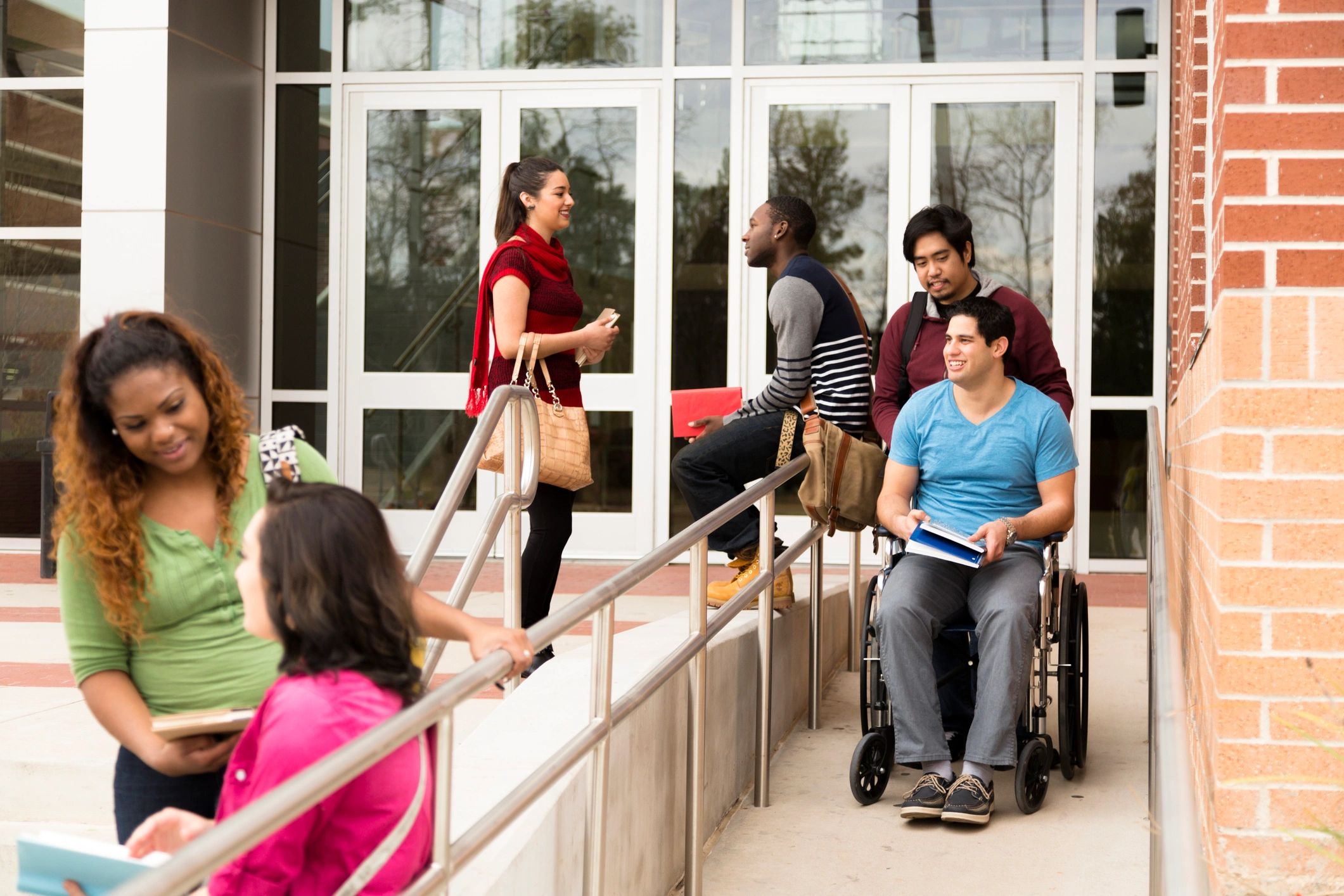 Disabled student on a college campus with peer support